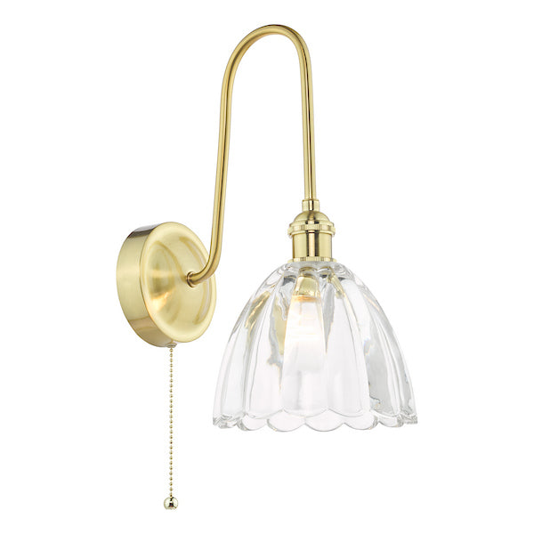 Gold wall-mounted light fixture with a clear scalloped glass shade with pull cord switch on a white background