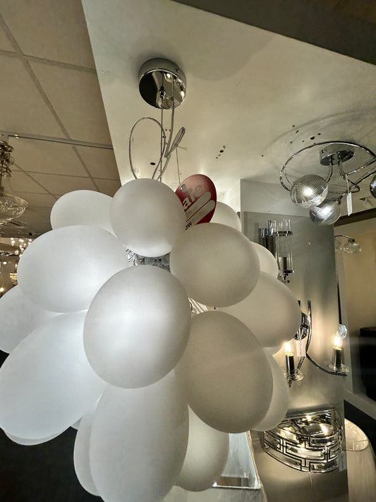 Dar Lighting modern chandelier with spherical glass shades in a kitchen setting