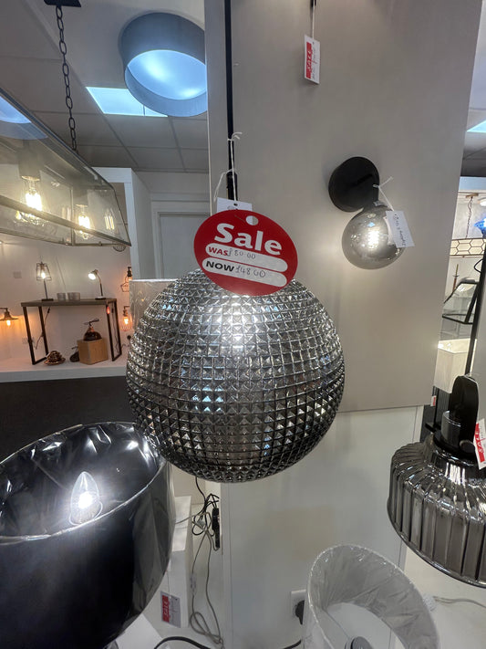 Dar Lighting crystal disco ball with a 'Sale' sign on a white surface in a store setting.