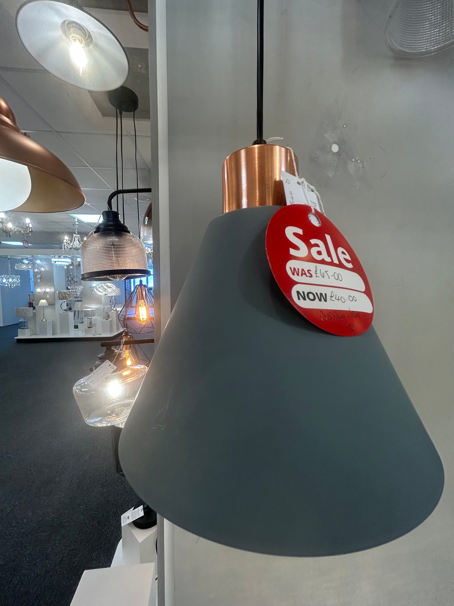 Dar Lighting futuristic lamp with a 'Sale' tag on a reflective surface