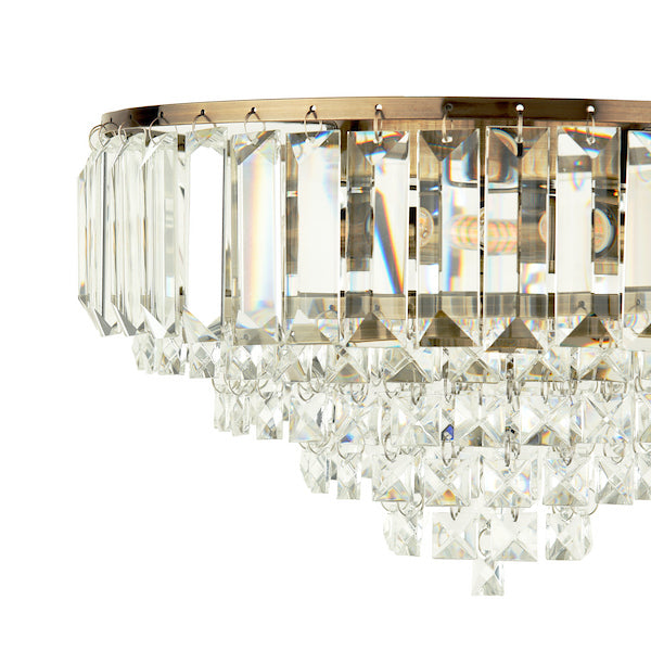 Crystal and antique brass flush ceiling light on a white background