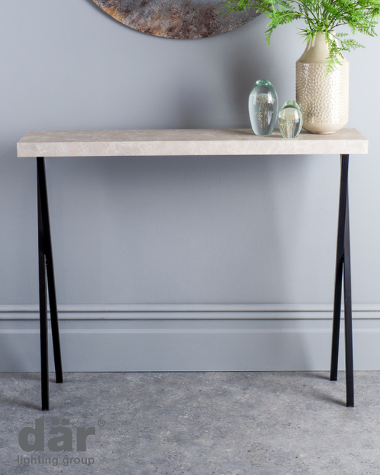 Dar lighting console table with a light wooden top and black metal legs against a gray wall.