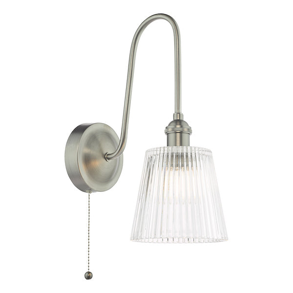 Wall-mounted light fixture with a clear ribbed glass shade with a pull cord on a white background.