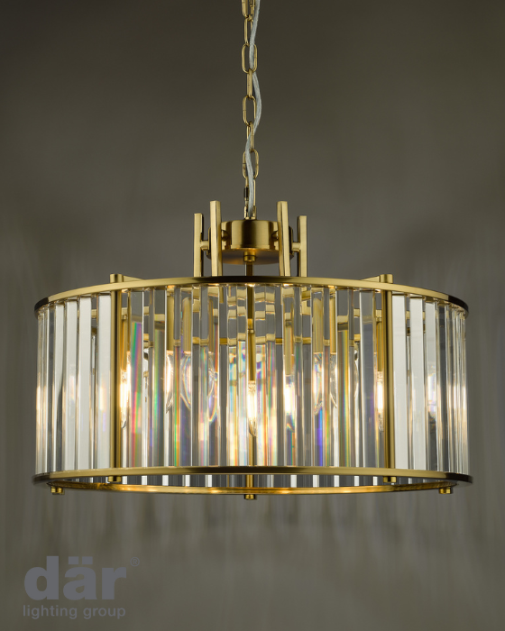 Gold dar lighting pendant light with glass shade on a gray background