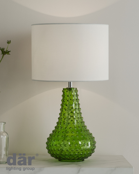 Green textured dar lighting table lamp with a white shade on a neutral background