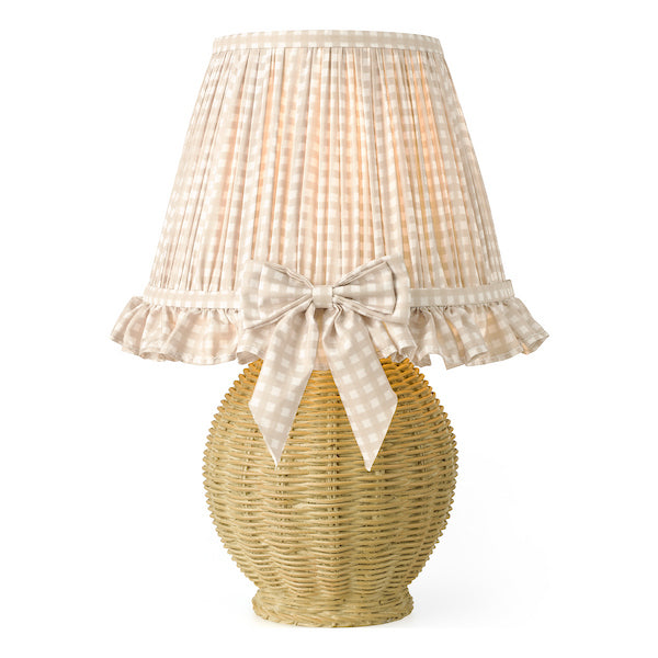 Wicker table lamp with a checkered lampshade and ribbon bow on a white background