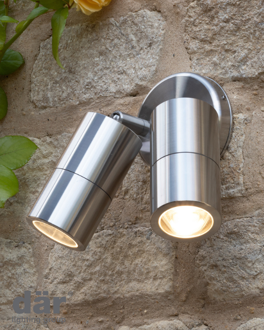 Metallic outdoor wall light fixture on a stone wall with dar lighting branding.