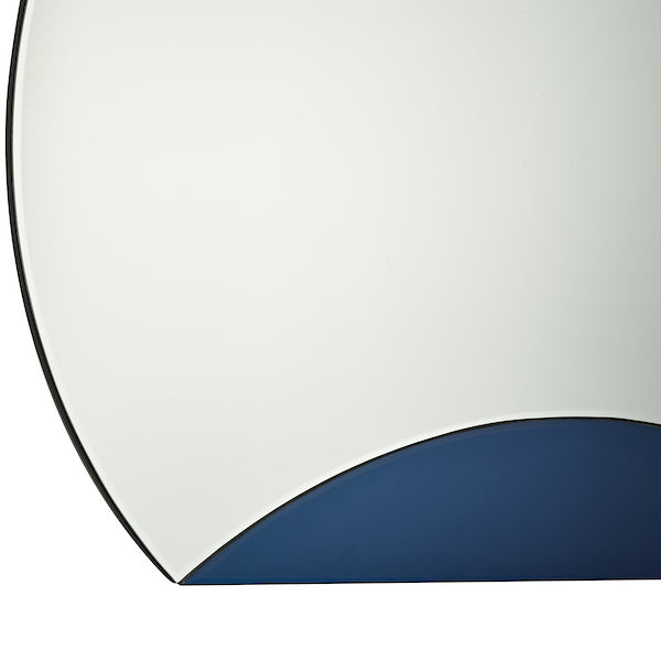 Close up of round mirror with squared off bottom and blue panel on a white background. 