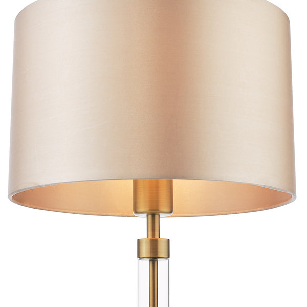 Dar lighting lamp with beige shade and gold base on a white background
