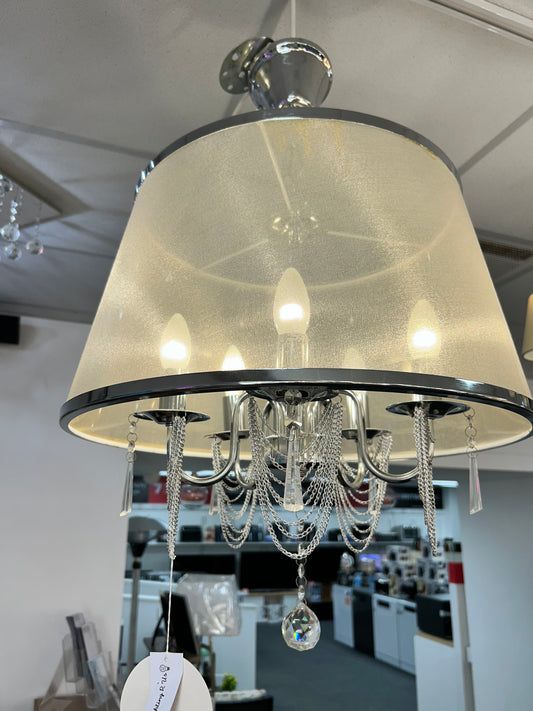 Searchlight close-up of a decorative lamp with a beige shade and metallic accents.