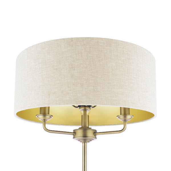 Close up natrual shade with antique brass floor lamp base on a white background.